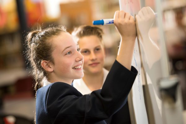 Student writes on whiteboard
